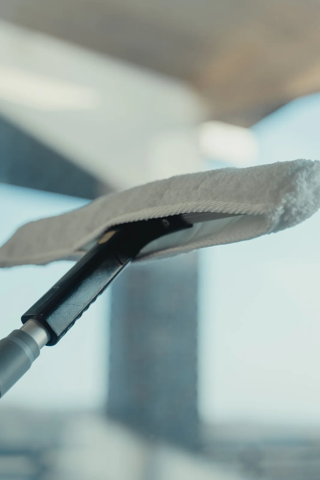 Close-up of a professional vacuum nozzle cleaning a hard floor