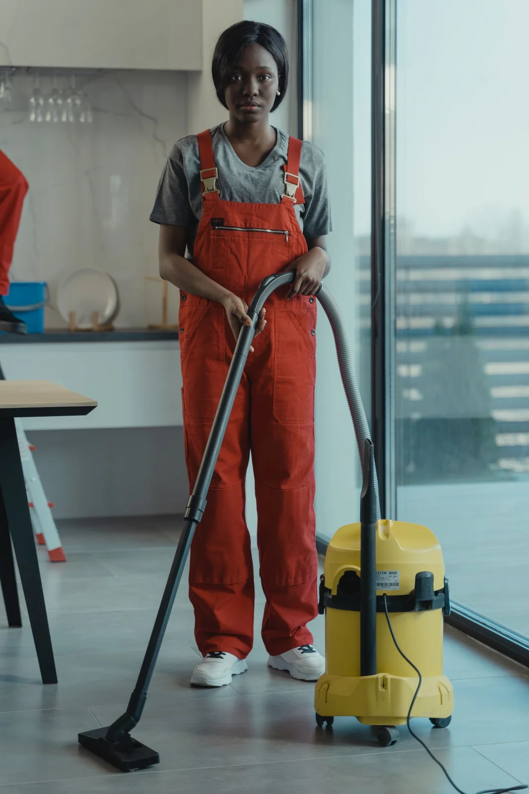 Cleaner in uniform operating a commercial vacuum